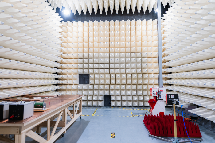 Interior of an RF anechoic chamber with electromagnetic wave–absorbing foam panels for EMI and EMC testing.